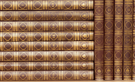 stacked encyclopedias.
