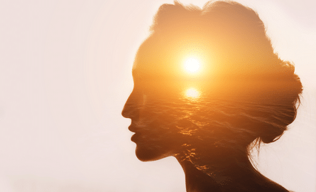 emanating sun behind a woman's profile