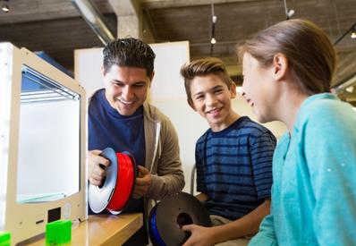 man showing two children how to use tools